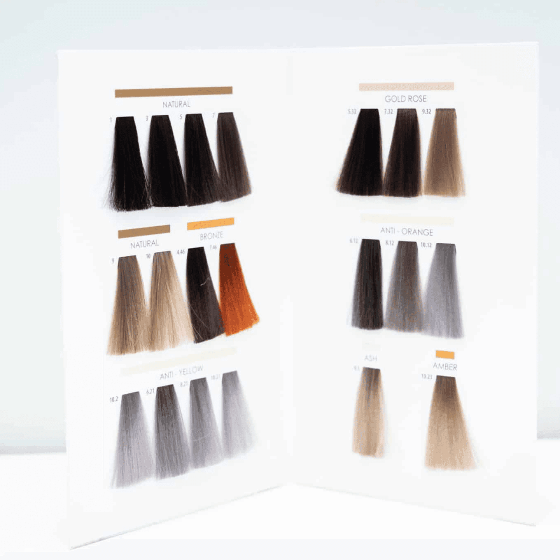 Open hair color sample book with various shades including natural, bronze, gold rose, and ash.